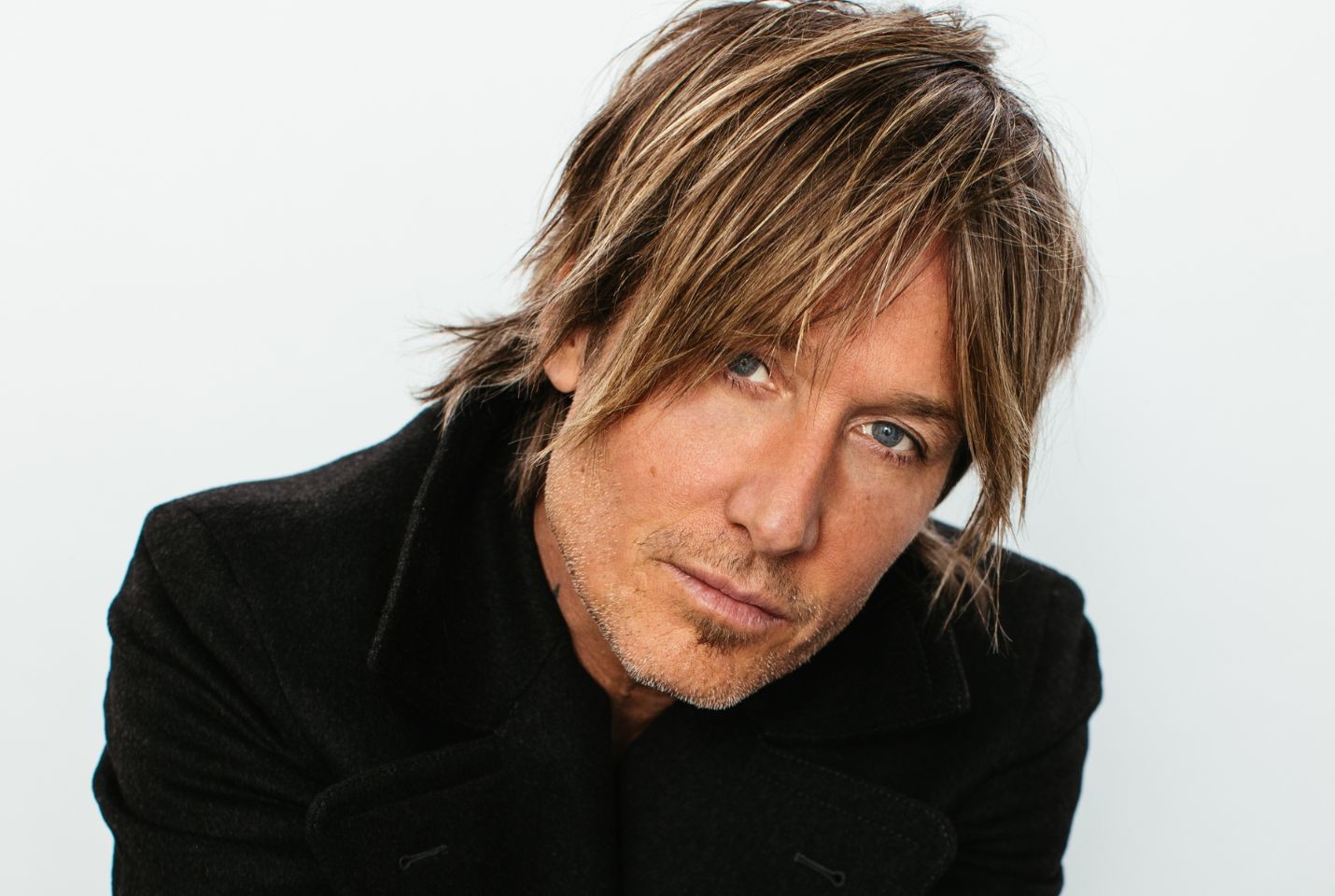 A close up image of Keith Urban wearing a black jacket